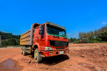 construction site digger, excavator and dumper truck. industrial machinery on building site, Dump truck is moving down sand on construction, truck on site