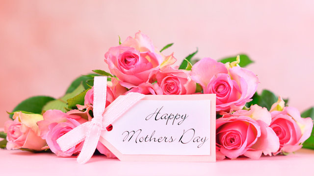Pink roses on pink wood table, Happy Mother's Day background closeup with gift card