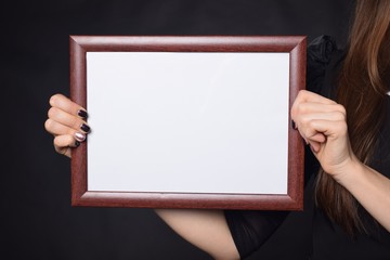 In the hands of a businessman a frame with the inscription: