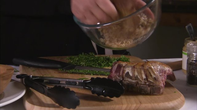 A medium shot of a person chopping garlic