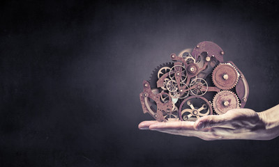 Cogwheel mechanism in hand. Mixed media