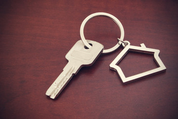 Key with keychain on table, concept for real estate or renting home
