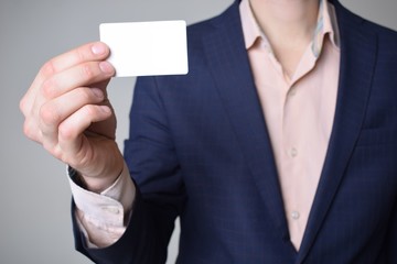 Fototapeta premium Businessman shows business card with the inscription:
