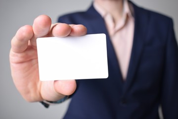 Businessman shows business card with the inscription: