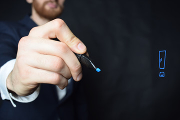 The businessman writes a blue marker inscription: