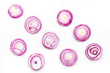 Ring of fresh red onion on white background top view space pattern