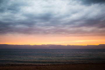 Line of sunset over the sea and sky with clouds