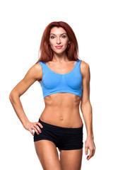 Fototapeta premium Muscular young woman athlete standing on white background. Woman bodybuilder relaxing after exercise.