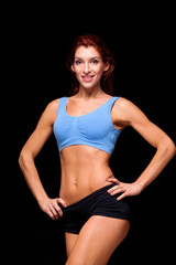 Fototapeta na wymiar Sporty beautiful woman doing fitness exercising at black background to stay fit. Fitness workout motivation.