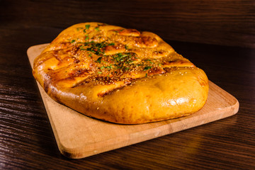 Pita bread with garlic on a wooden cutting board
