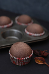 Just Baked Homebaked Chocolate Muffins for Dessert with colored Conffeti. Dark Background.