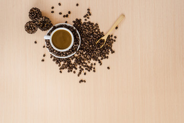 Cup of coffee , coffee beans and spoon on the table with copy space background