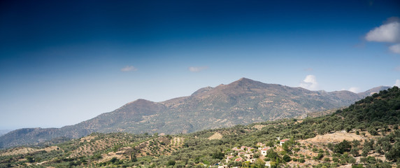 Field and mountain against sky against sky