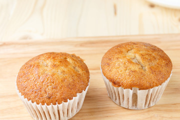 Banana cup cake are placed on wooden floors with copy space