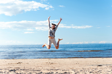 Fototapeta na wymiar Young cheerful jumping teenage girl excitement at seaside