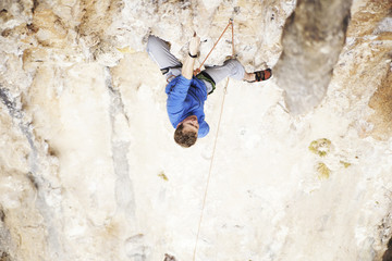 Rock-climbing in Turkey. The climber climbs on the route. Photo from the top.