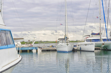 Fototapeta premium Berth with moored nameless yachts against