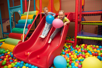 Kids playing in a pool of balls