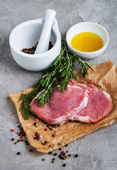 Fresh raw pork chops with spices and herbs