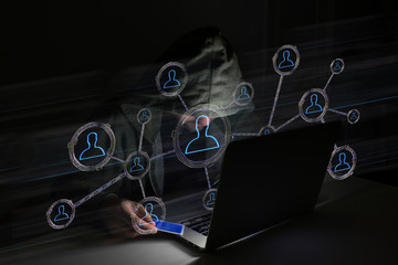 Hacker man in the dark using computer to hack data and information system