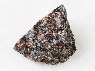 raw spreusteined urtite stone on white