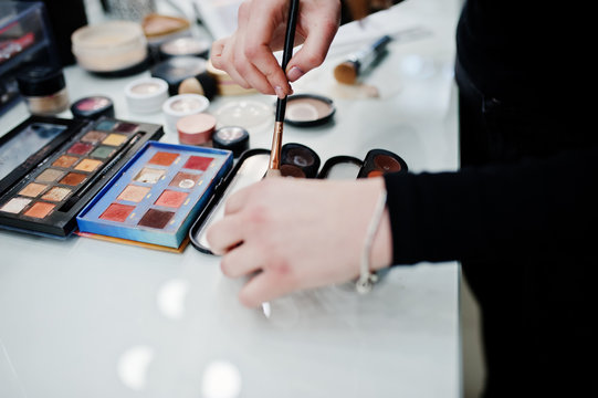 Many brushes on a table in the salon. Workplace makeup artist. Set of brushes for makeup.