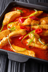 Spicy chicken pangang curry close-up on a plate on a table. vertical