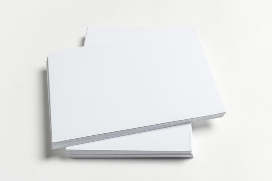 White business card on wooden table. Blank portrait A4.