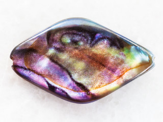 bead from Abalone (haliotis) shell on white marble