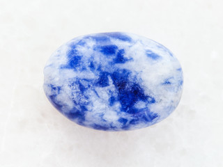 Obraz na płótnie Canvas bead from Lapis lazuli gemstone on white marble