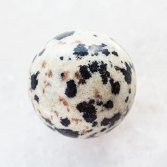 ball from Dalmatian Jasper gemstone on white - obrazy, fototapety, plakaty