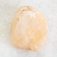 yellow marble pebble on white marble