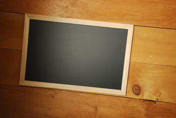 Chalk board top view with wooden background