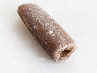 fossilised rostra of belemnoid on white