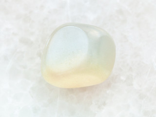 polished translucent moonstone gem stone on white