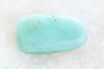 polished Aquamarine gemstone on white marble