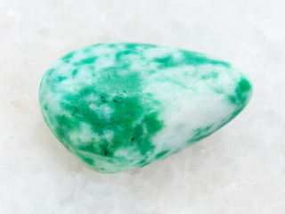 tumbled amazonite gem stone on white marble