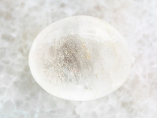 polished white agate gemstone on white marble