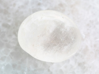 tumbled white agate gemstone on white marble