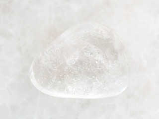 tumbled Rock-crystal gem stone on white marble