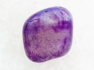 polished Amethyst crystal gem on white marble