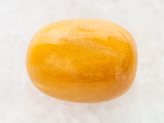 polished yellow jasper gemstone on white marble