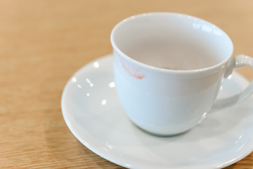 Fototapeta na wymiar lipstick stain from a woman on ceramic coffee cup - coffee break