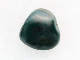 tumbled heliotrope gemstone on white marble