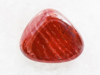 polished red jasper gem stone on white marble © vvoe