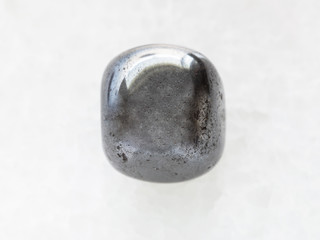 polished hematite stone on white marble