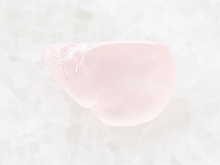 polished rose quartz gemstone on white marble