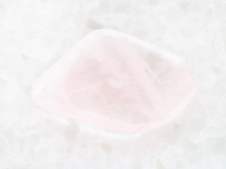 polished pink quartz gem stone on white