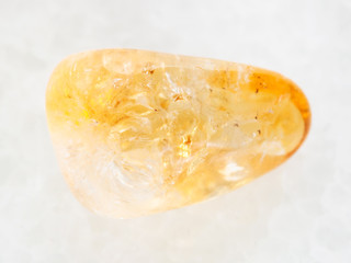tumbled Citrine gemstone on white marble