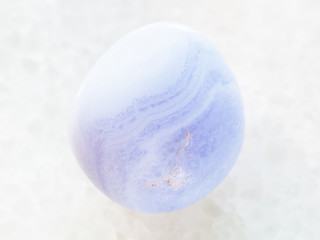 Fototapeta na wymiar polished blue chalcedony gemstone on white marble